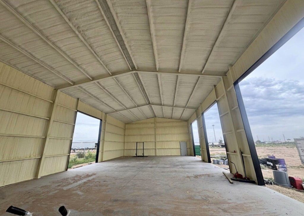 Large metal building with walls and roof finished in spray foam