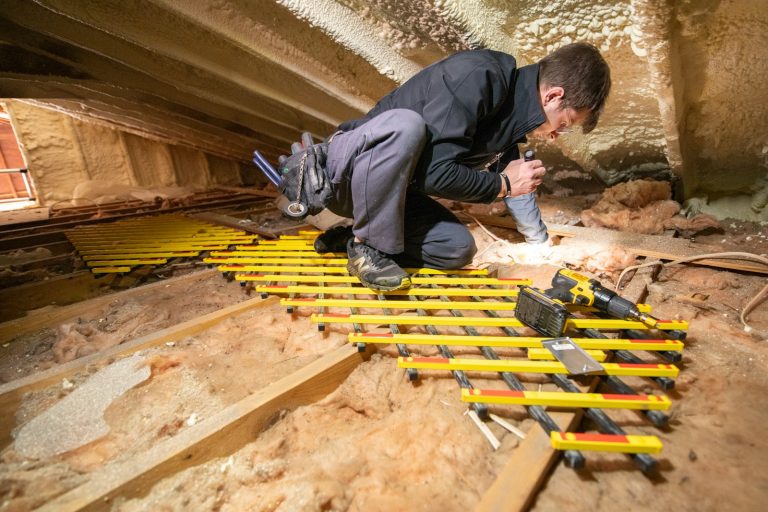 Worker in safety gear working in an attic
