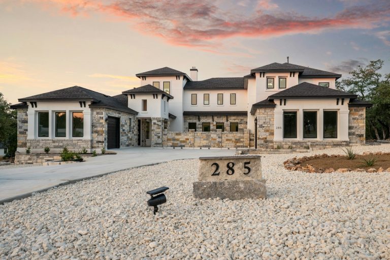 New stone and siding home at sunset