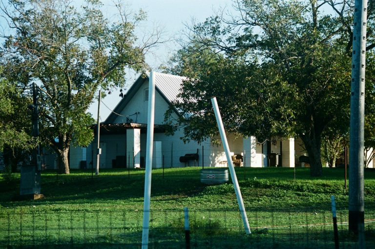 White farmhouse on open land in Texas